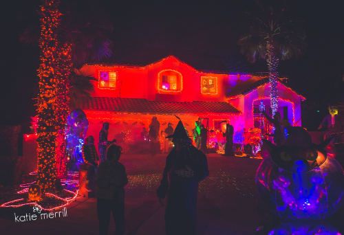 house decorated for Halloween and surrounded by trick-or-treaters